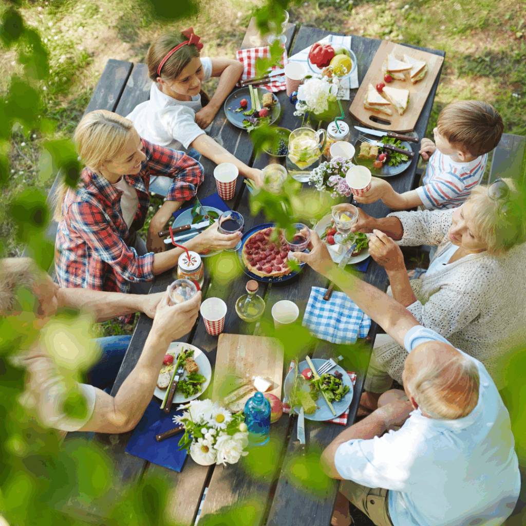 Grupa ludzi przy stole podczas pikniku